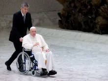 Pope Francis enters the Vatican’s Paul VI Hall in a wheelchair on May 5, 2022.