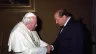 St. Pope John Paul II greets former Italian Prime Minister Silvio Berlusconi.