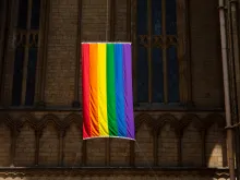 A pride flag hangs from the Peterborough Cathedral in England in 2019.