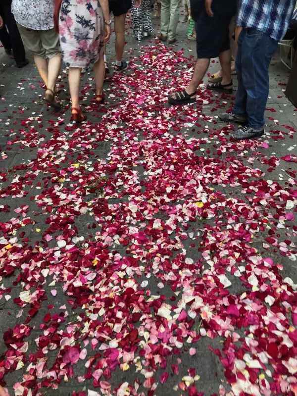 During the eucharistic procession in Valencia, Spain, on June 11, 2023, the eucharistic Lord is showered with red and white petals from two, three, five floors up. Credit: Courtesy of Rachel Thomas